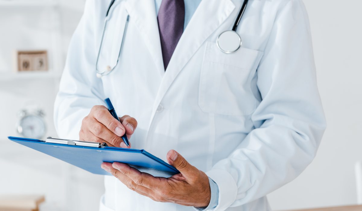 Cropped,View,Of,Doctor,In,White,Coat,Holding,Clipboard,And